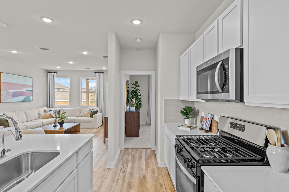 A kitchen with white cabinets.