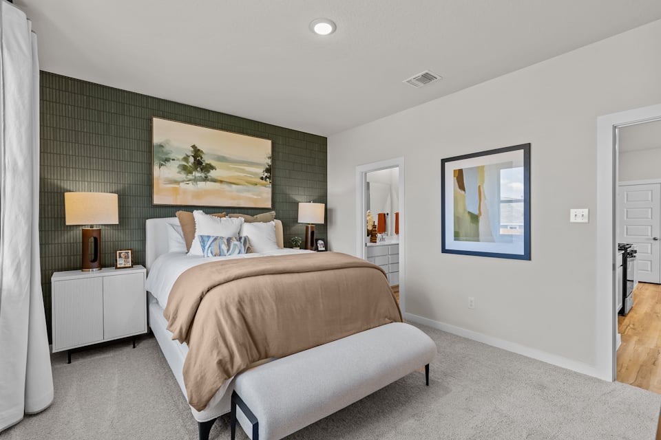 A bedroom with a bed and lamps.