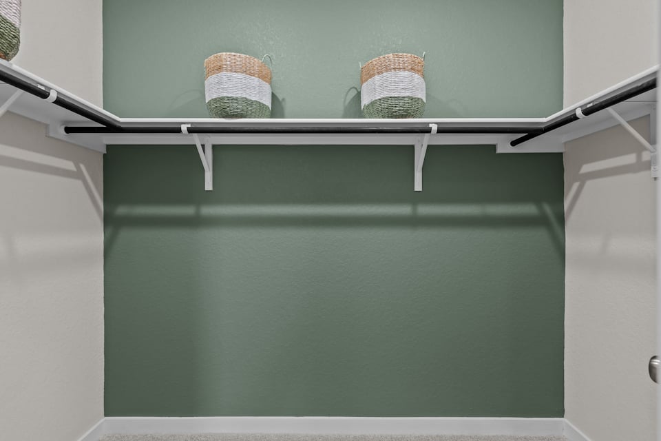 A couple of baskets on a shelf.