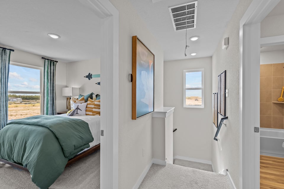 A bedroom with a bed and a window.