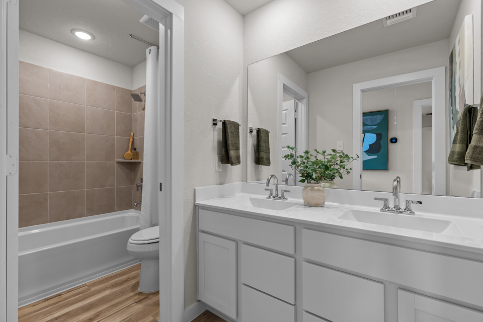 A bathroom with a tub sink and toilet.