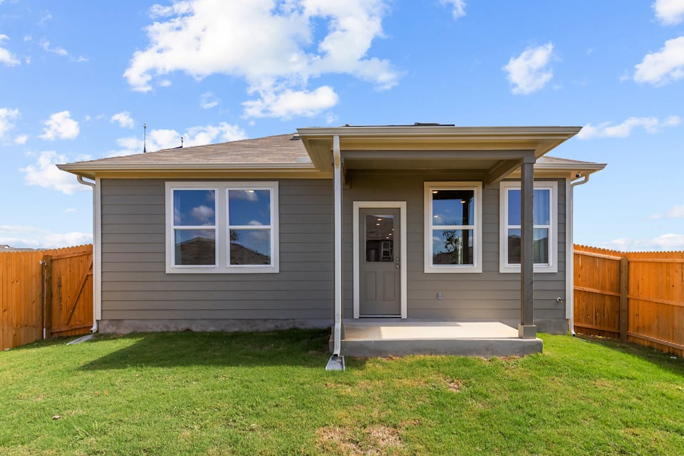 A small house with a fence.
