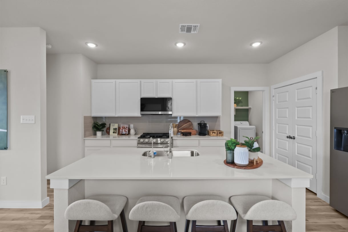 A kitchen with white cabinets.