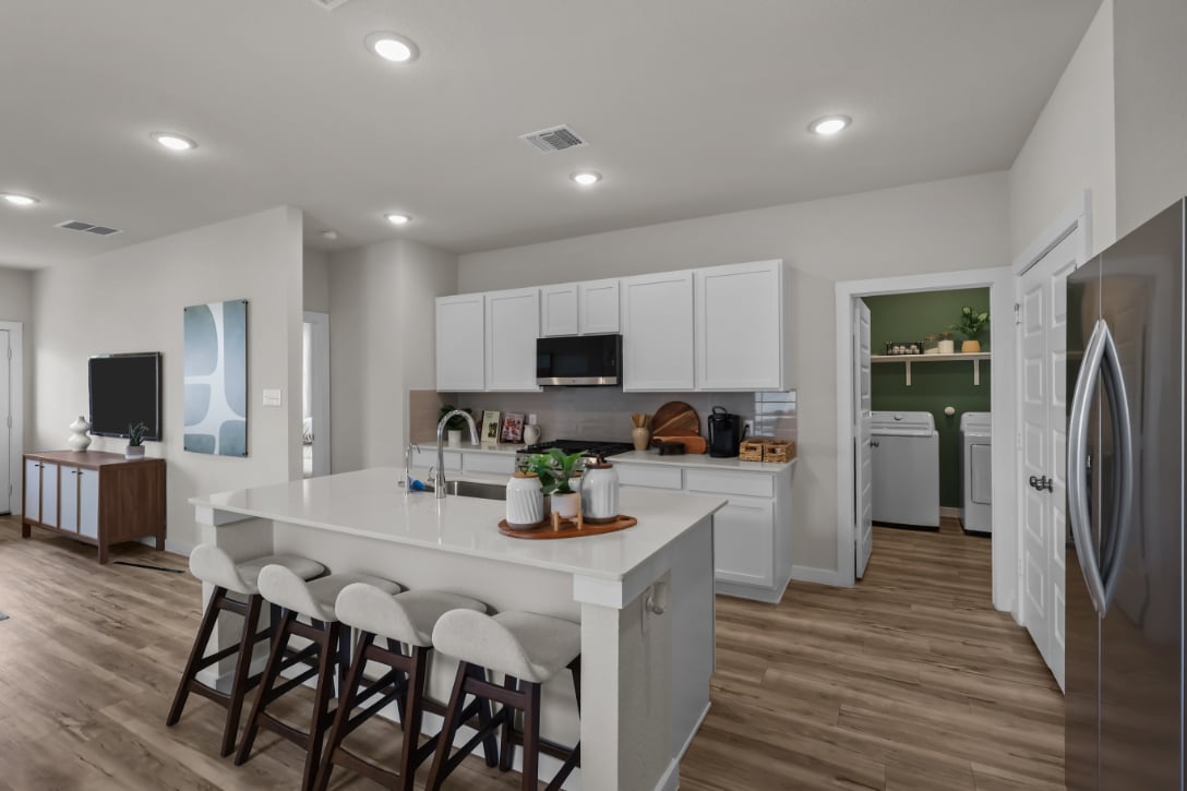 A kitchen with white cabinets.