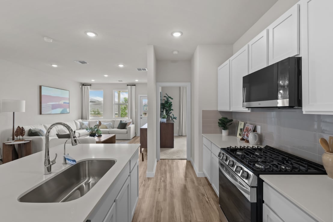 A kitchen with white cabinets.