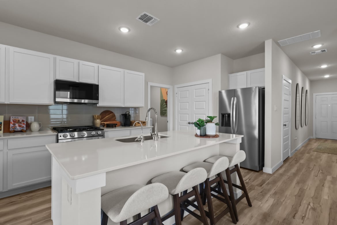 A kitchen with white cabinets.