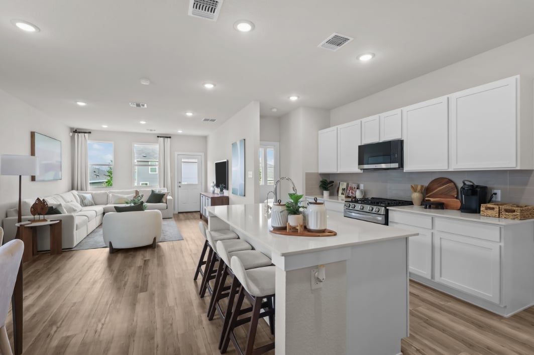 A kitchen with white cabinets.