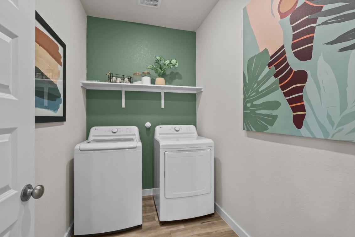 A room with a washer and dryer.