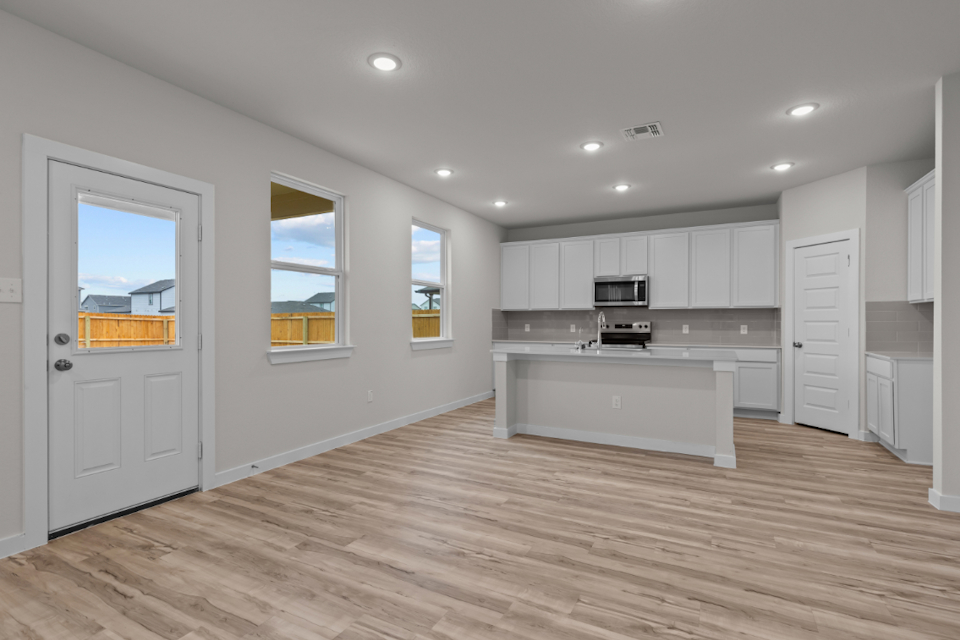A kitchen with white cabinets.