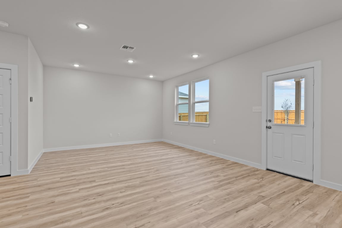A room with a wood floor and white walls.