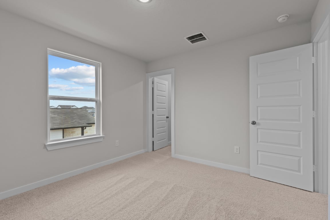 A room with a window and a door.