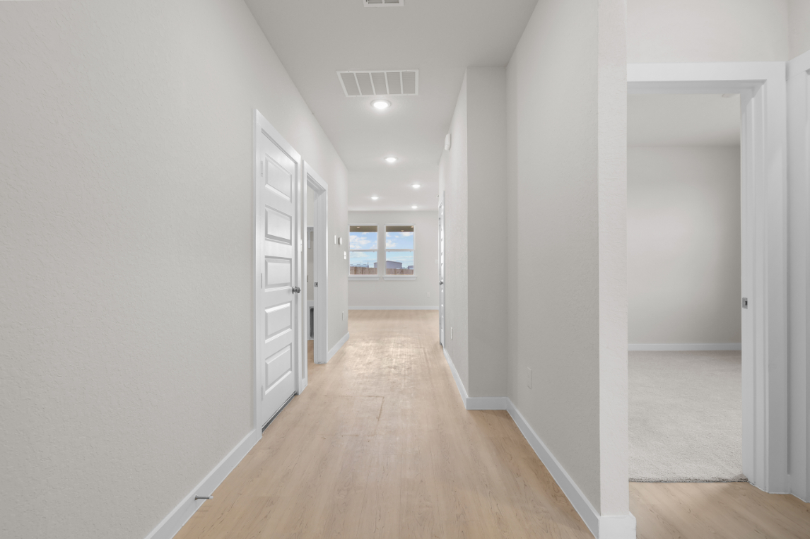 A hallway with white walls.