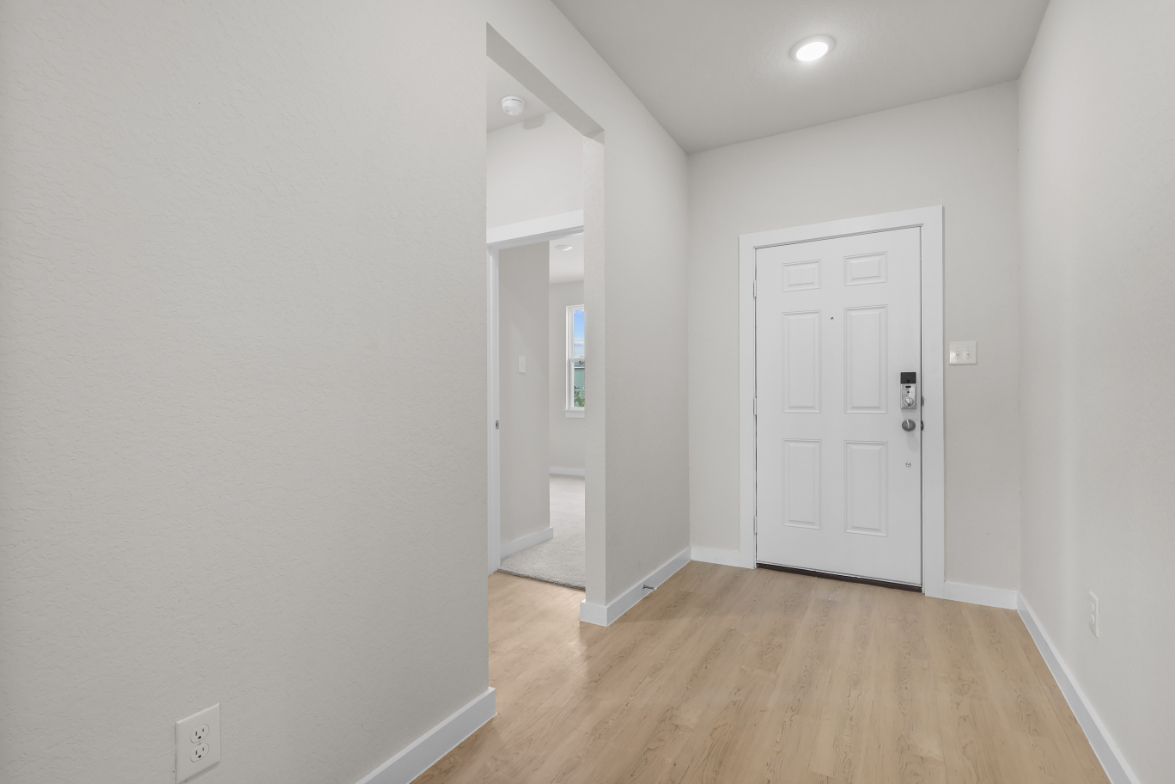 A hallway with white doors.
