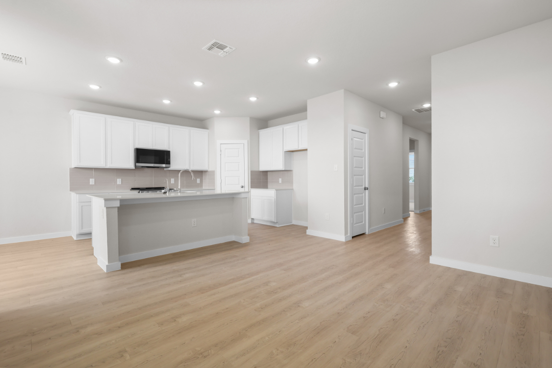A large kitchen with white cabinets.