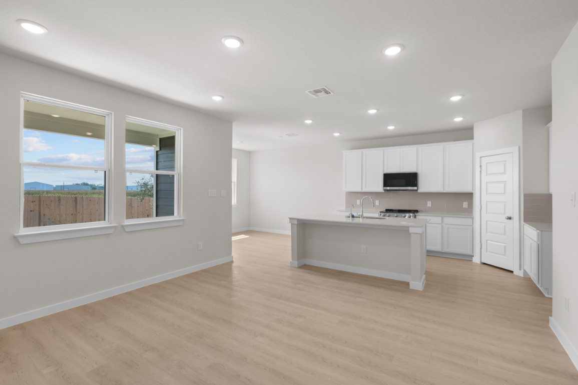 A large kitchen with white cabinets.