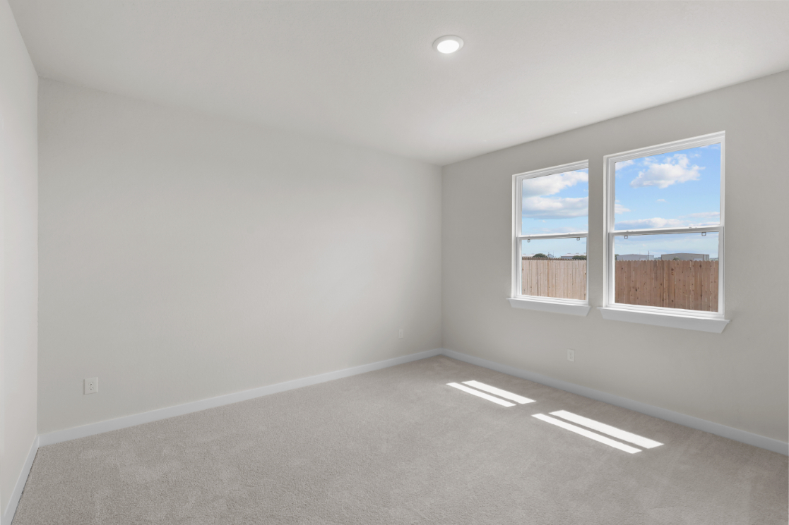A room with a window and a painting on the wall.