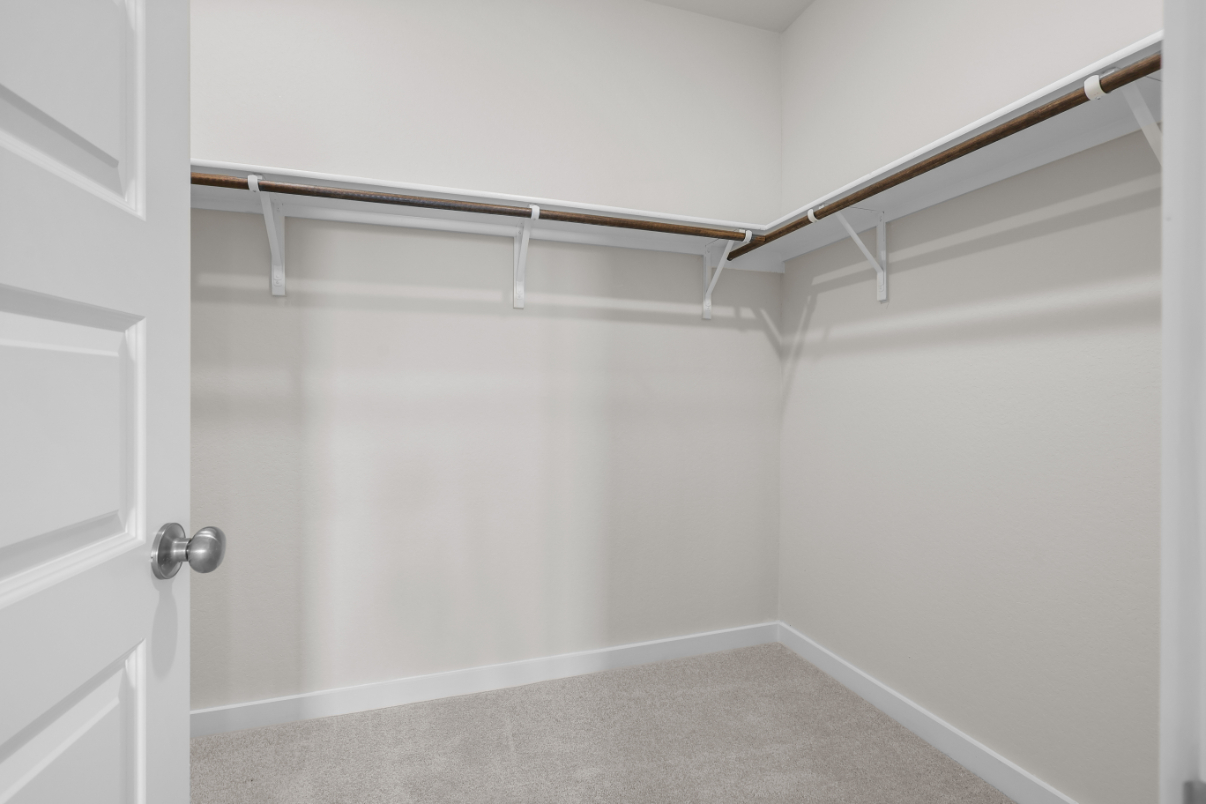 A white door with a metal bar.
