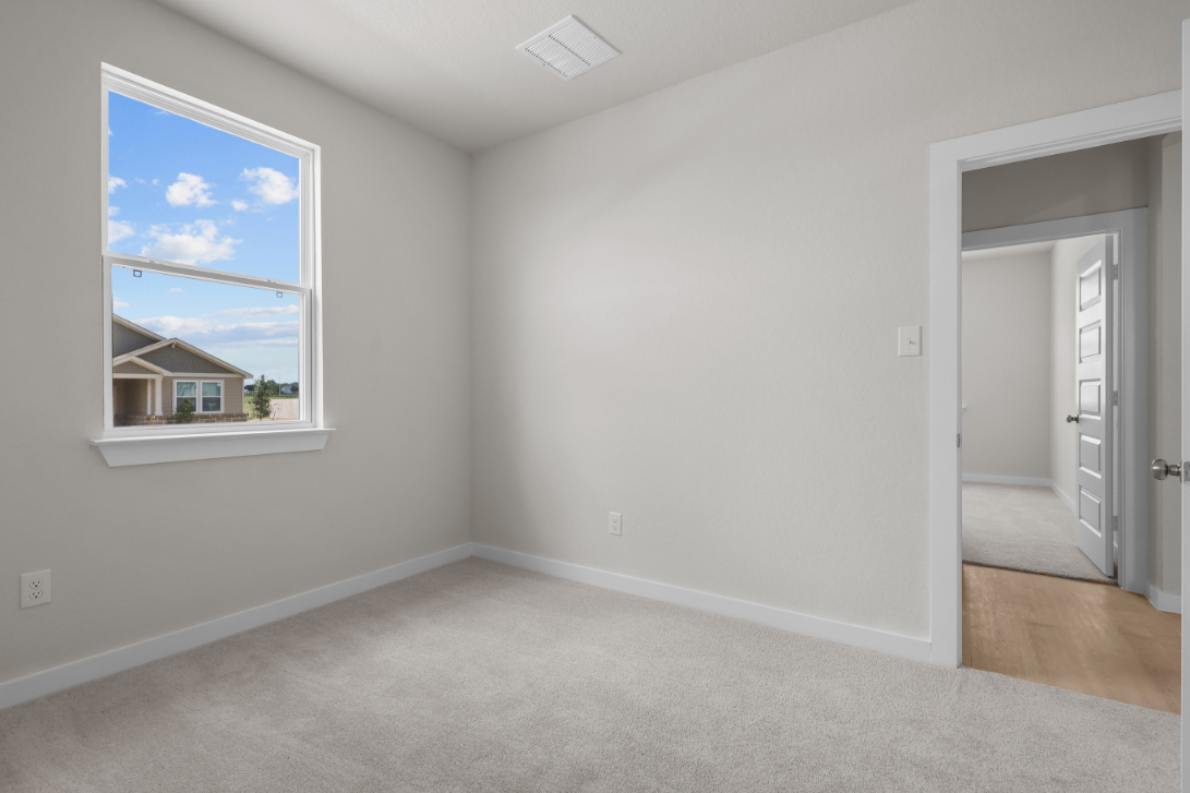 A room with a window and a door.