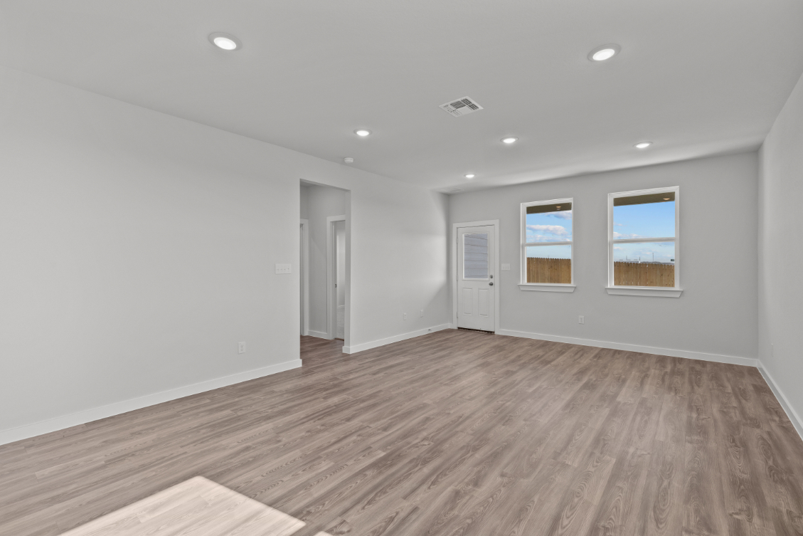 A room with a wood floor and white walls.