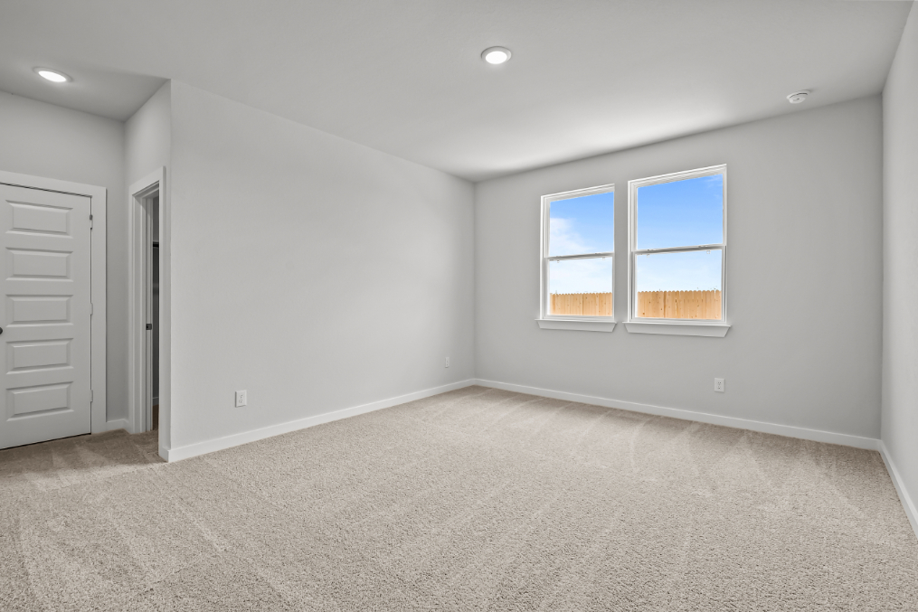 A room with a window and a carpet.