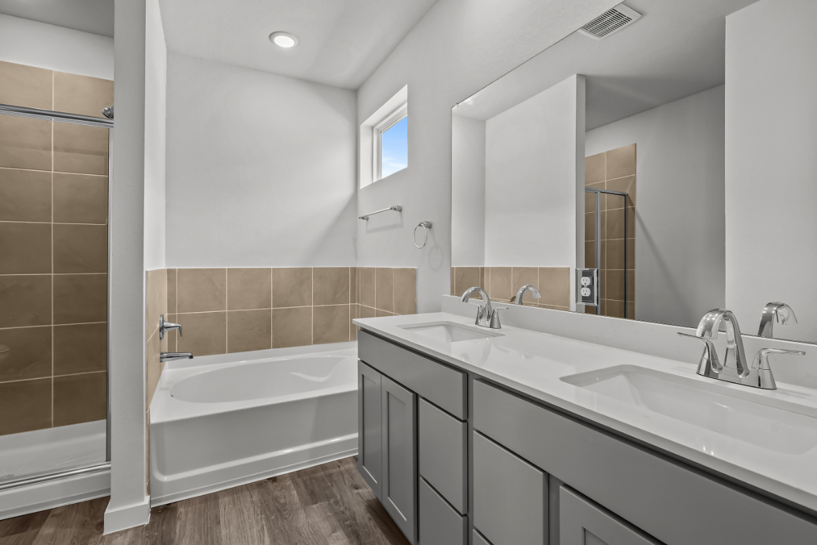 A bathroom with a tub sink and a bathtub.