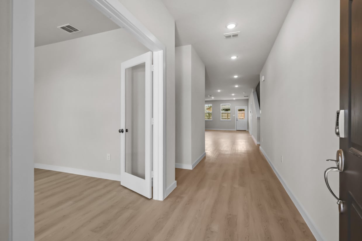 A hallway with white doors.