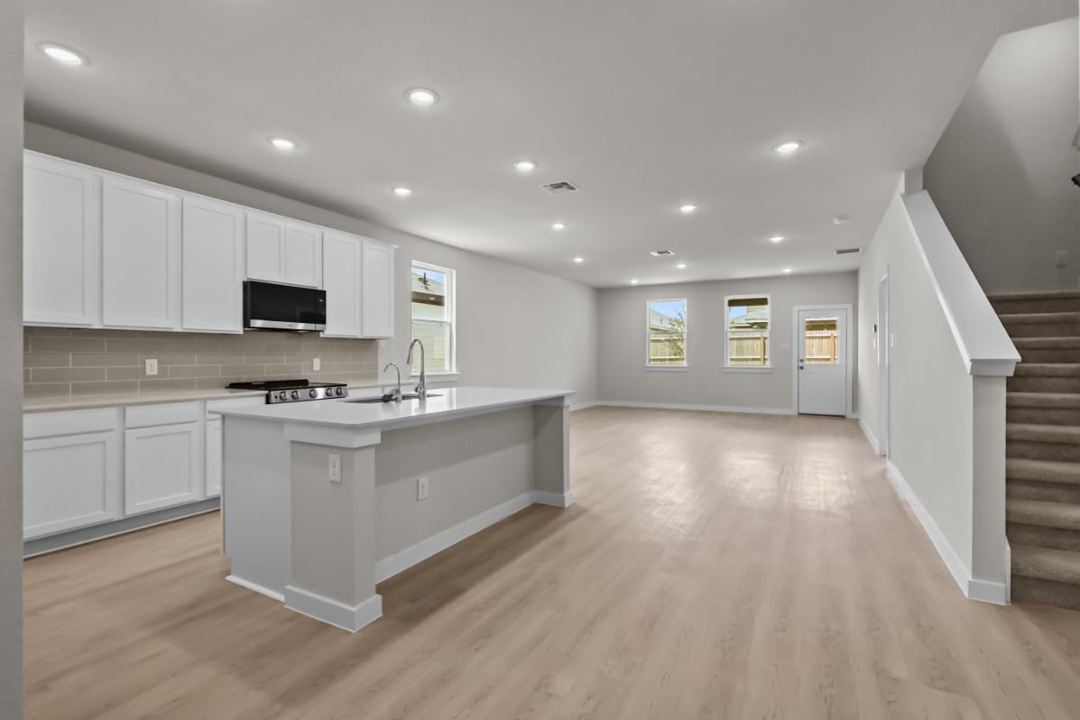 A kitchen with white cabinets.
