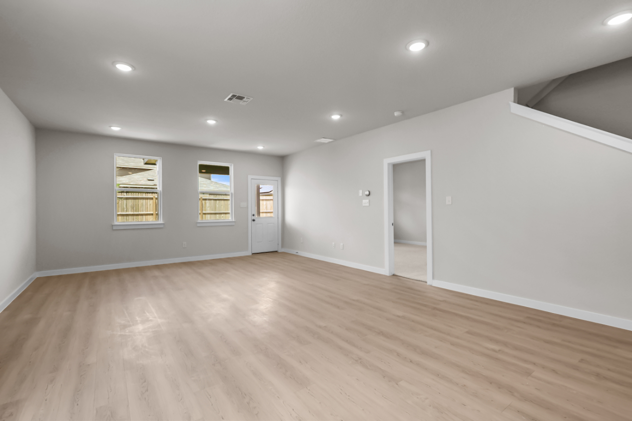 A room with a wood floor and white walls.