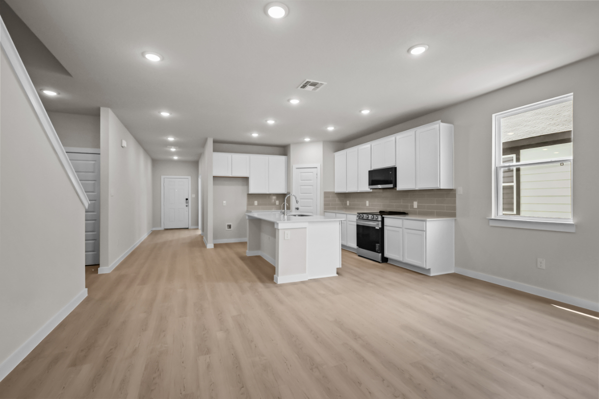 A large kitchen with white cabinets.