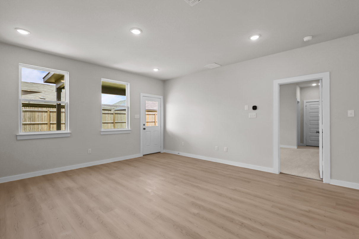 A room with a wood floor and white walls.