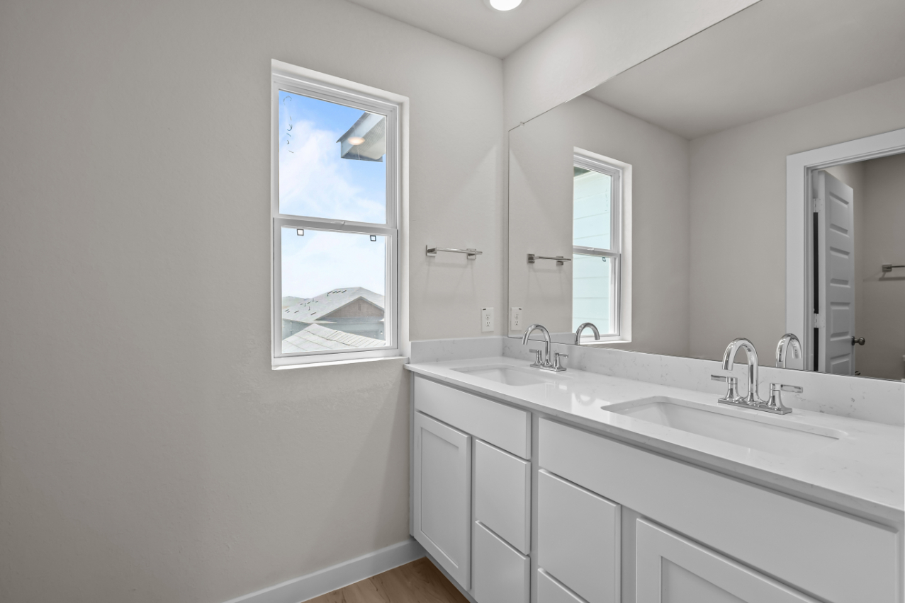 A bathroom with a large mirror.