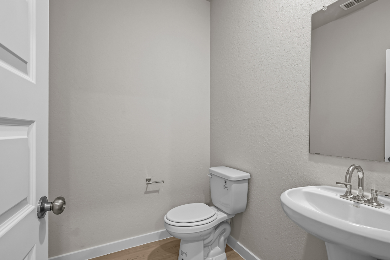 A bathroom with a toilet and sink.