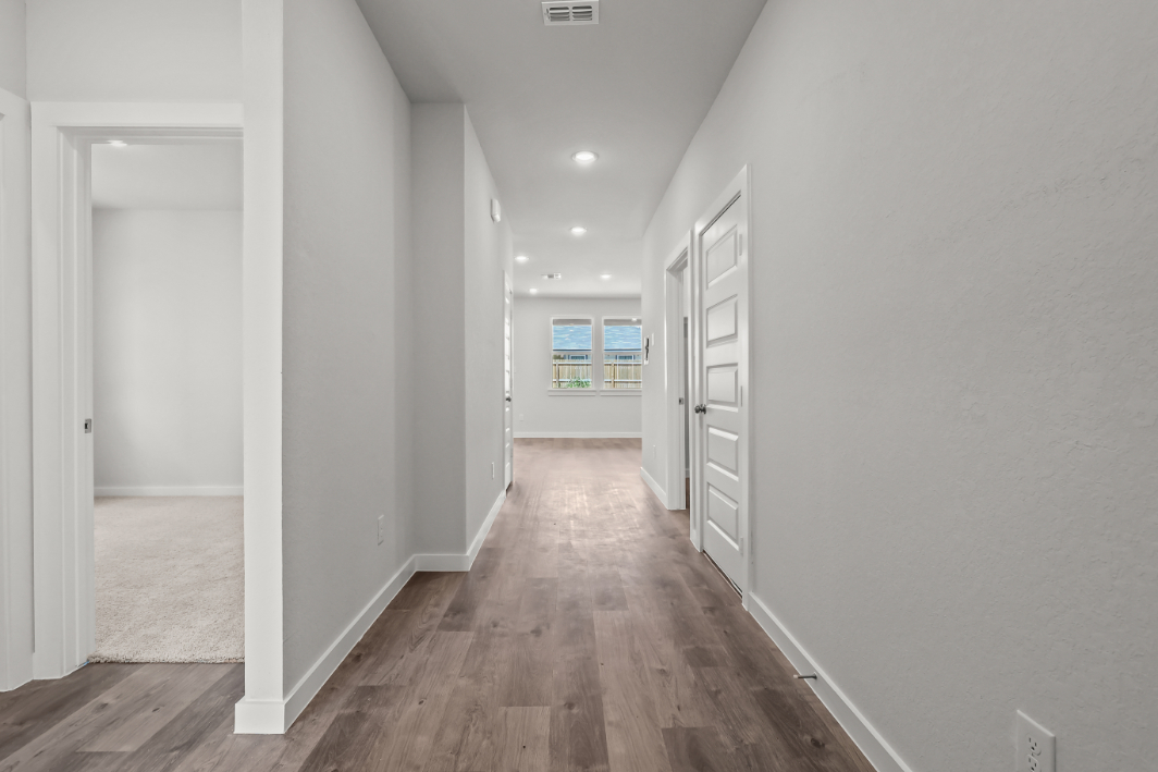 A hallway with white walls.