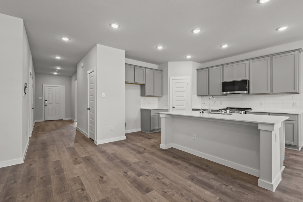 A kitchen with white cabinets.