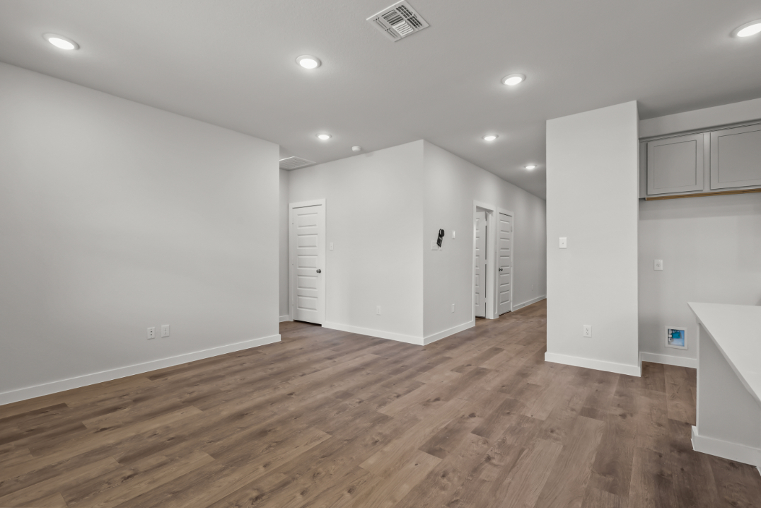 A room with white cabinets.