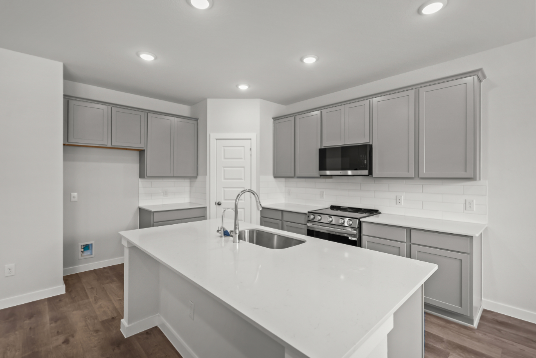 A kitchen with white cabinets.