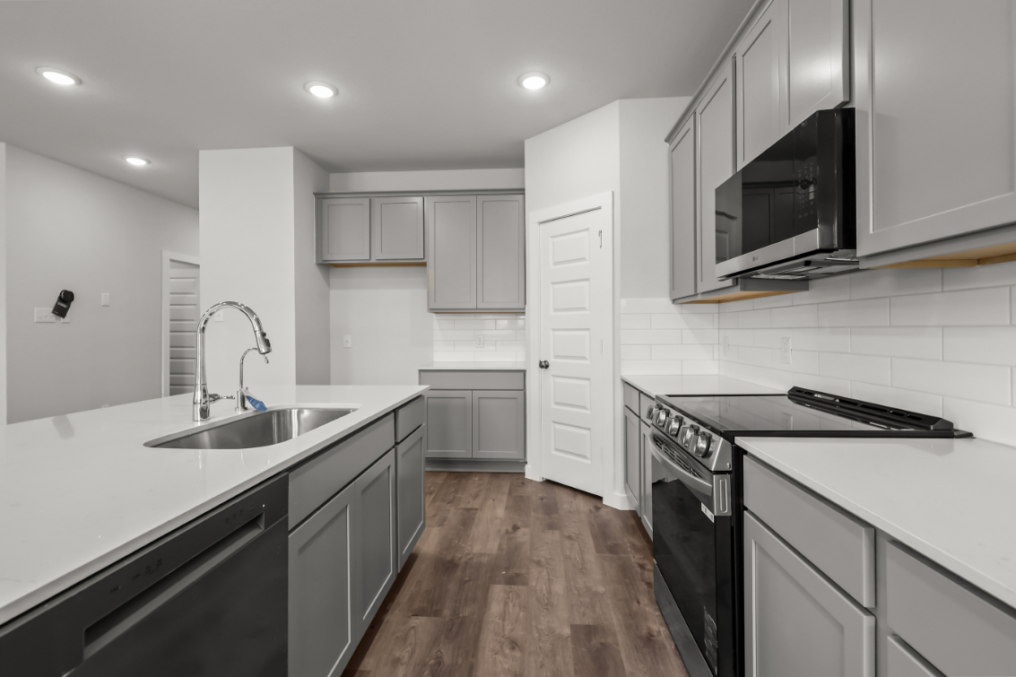 A kitchen with white cabinets.