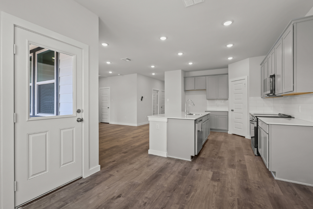 A kitchen with white cabinets.