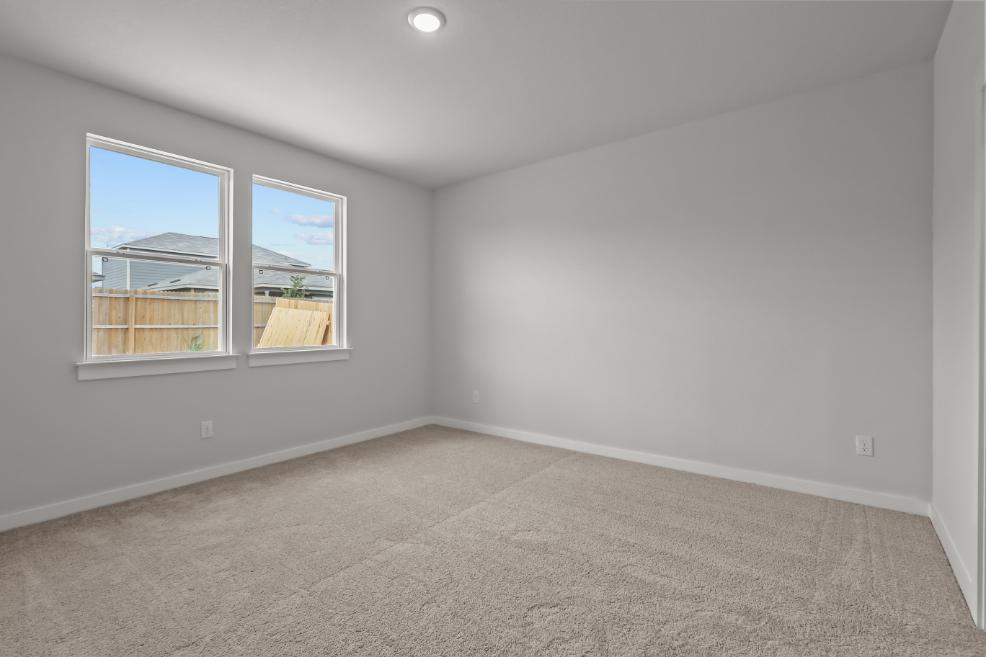 A room with a window and a carpet.