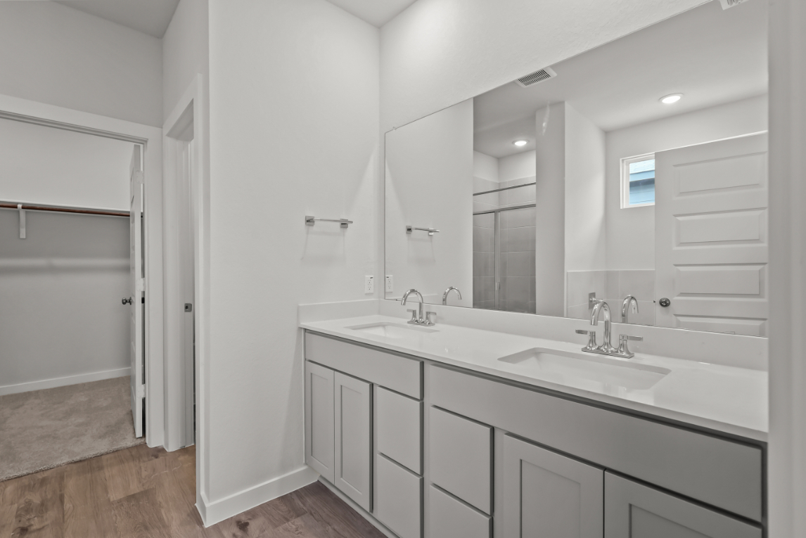A bathroom with a large mirror.