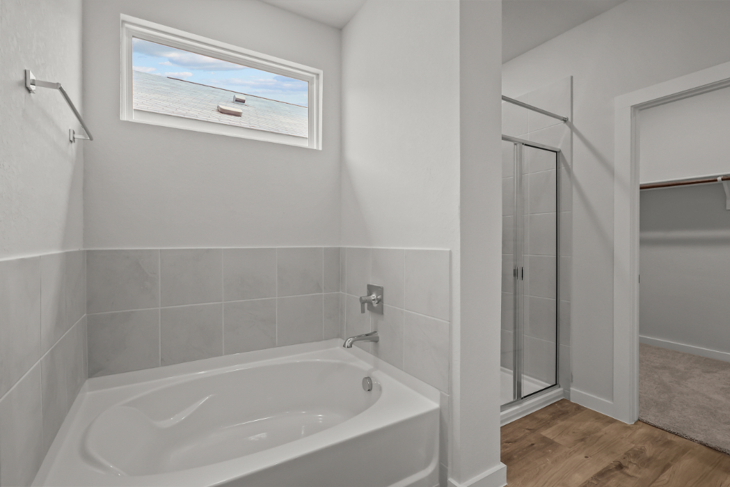 A bathroom with a tub and shower.