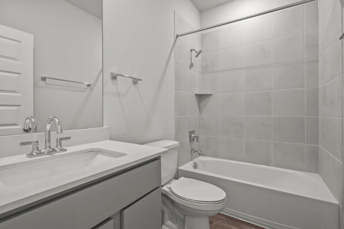 A bathroom with a sink toilet and bathtub.