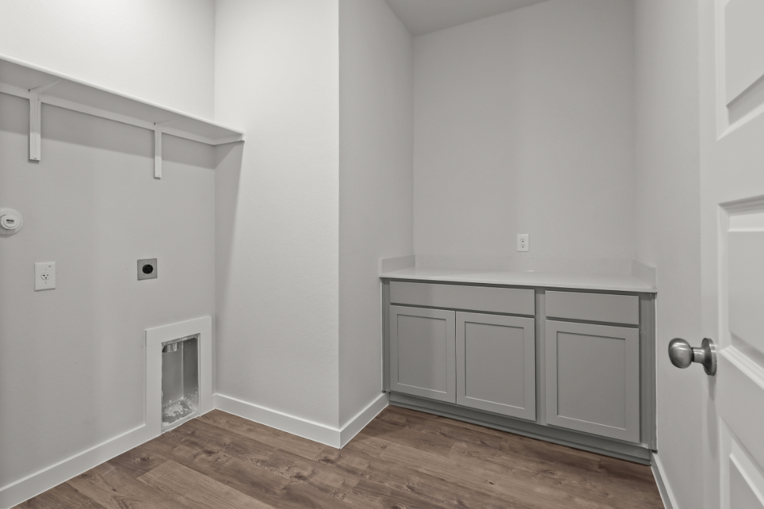 A white room with a wood floor.