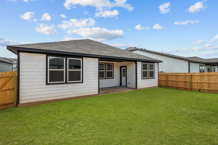 A house with a fence and grass.