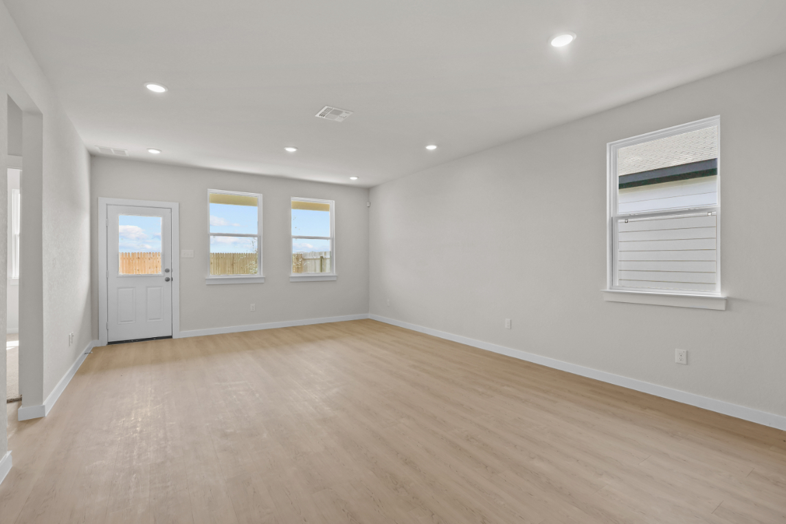 A room with a wood floor and white walls.
