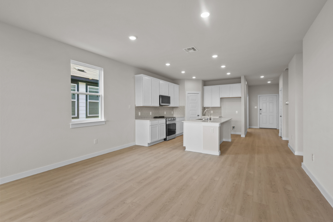 A kitchen with white cabinets.