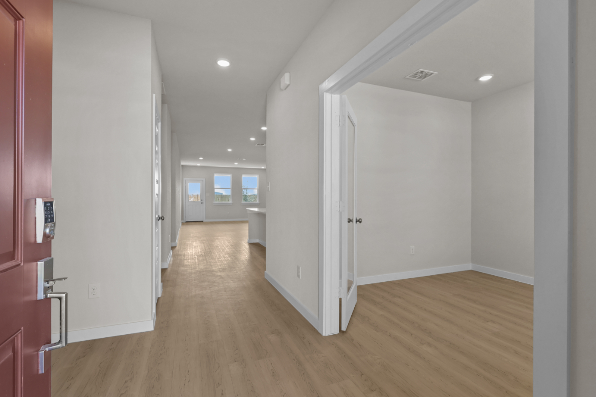 A hallway with white doors.