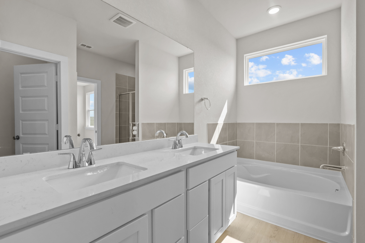 A bathroom with a large mirror.