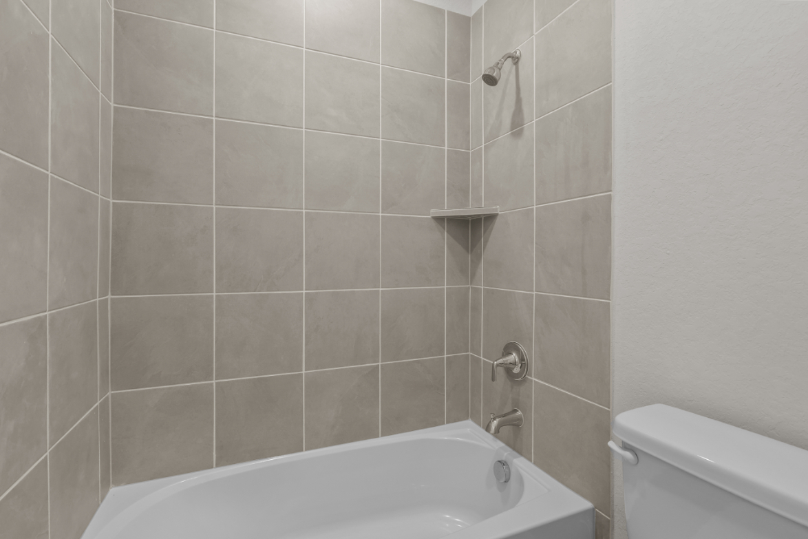 A bathtub in a bathroom.
