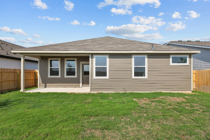 A house with a fence and grass.